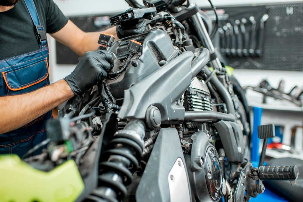Electrician repairing motorcycle wiring